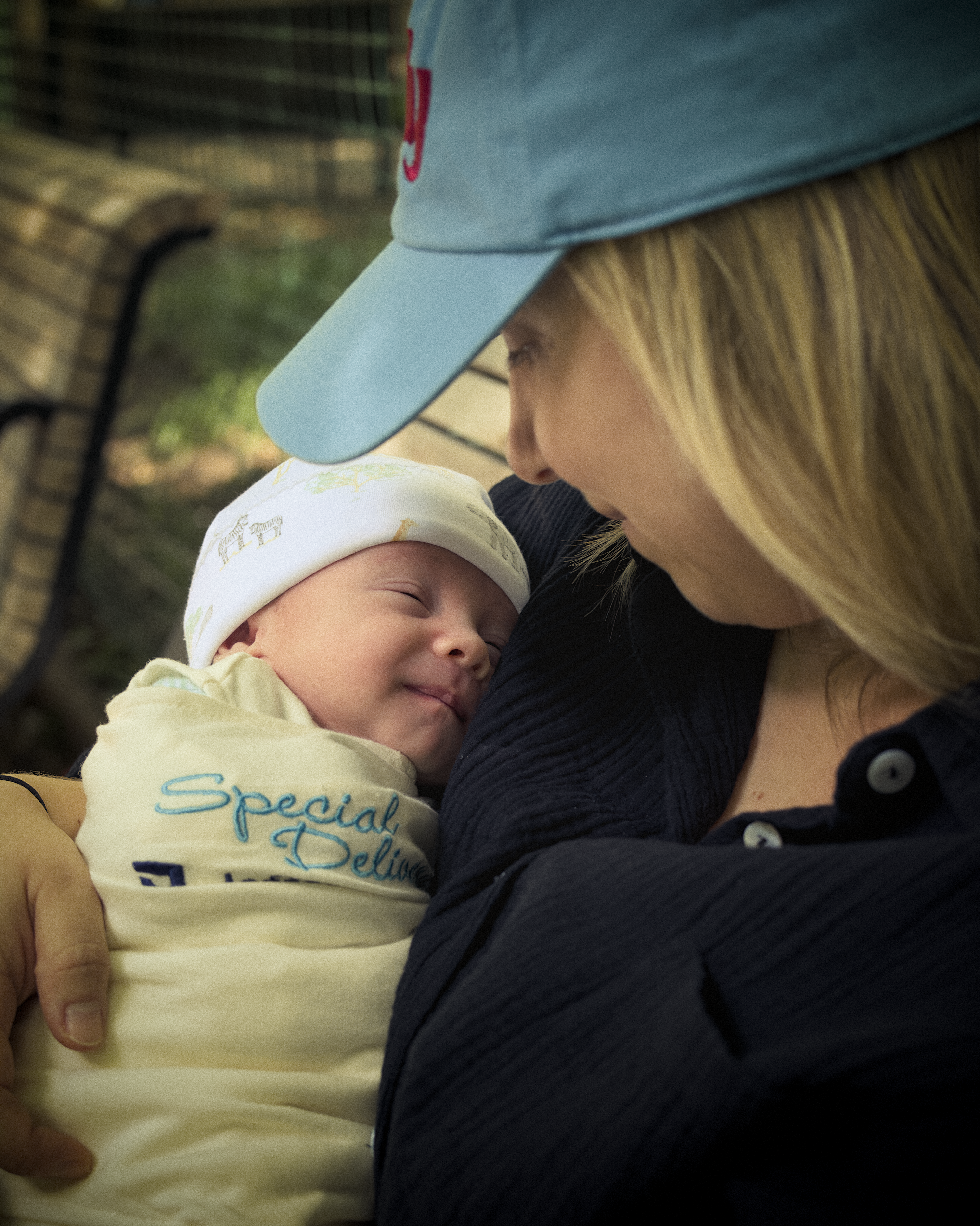 Nate sleeping in Nicole's arms outdoors